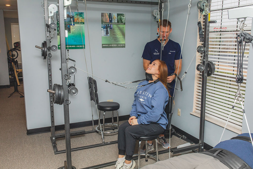 Dr. Longo adjusting the back of a young man during chiropractic treatment for back pain